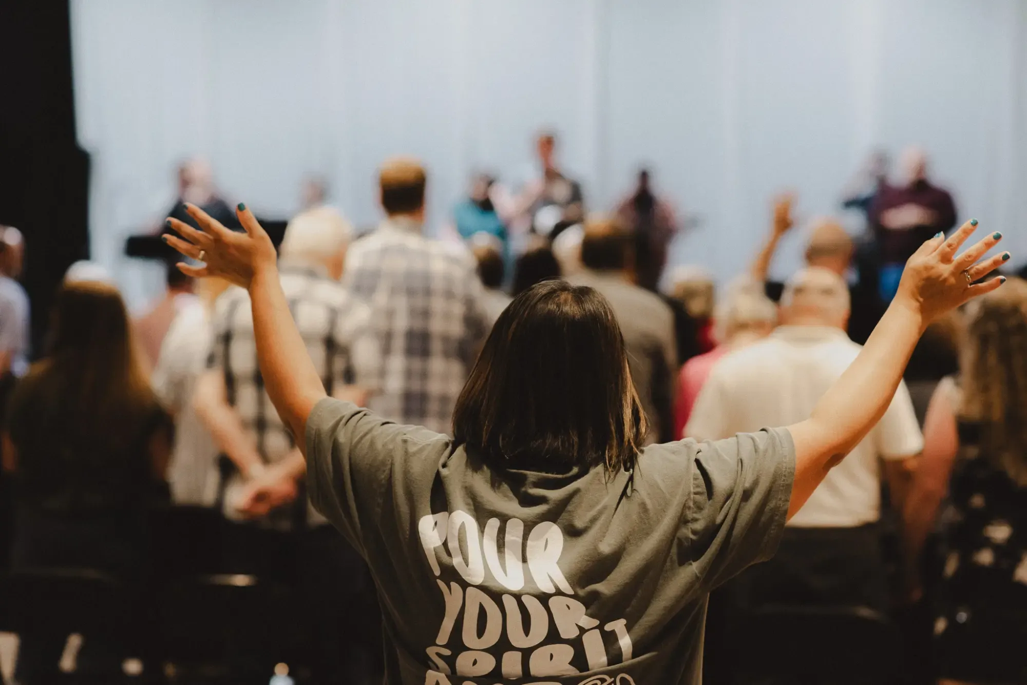 Woman with arms raised in worship